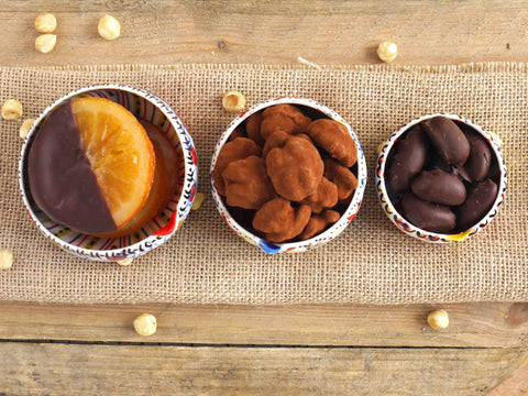 Orange slices in dark chocolate and walnuts in milk chocolate and dark brazils