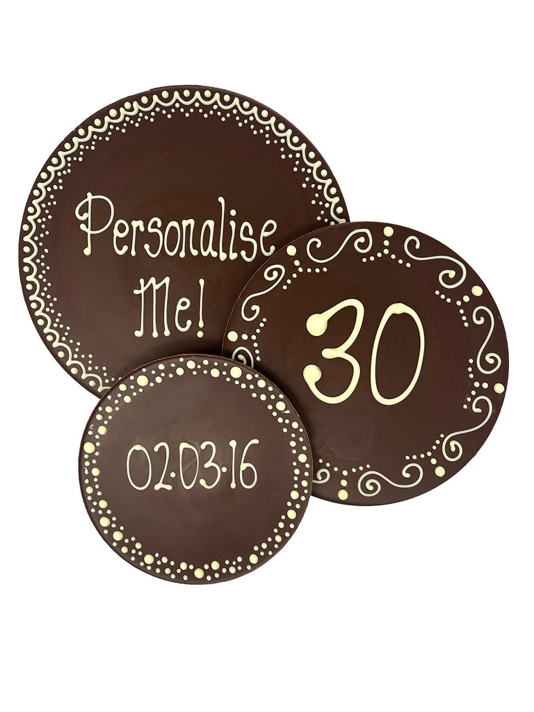 3 Milk chocolate plaques hand piped with decorative borders and 'Personalise Me!' '30' and a calendar date text in white chocolate. On a white background.