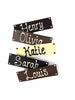 Five chocolate bars in milk, dark and white chocolate with names piped on. Arranged on a white background.