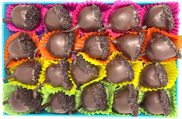 Open chocolate box with 20 dark chocolate cherry liqueurs. Each chocolate sits in a colourful paper case. Viewed from above.