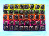 Open gift box of 40 cherry marizipans in dark chocolate. Each one decorated with a whole dried cherry.  