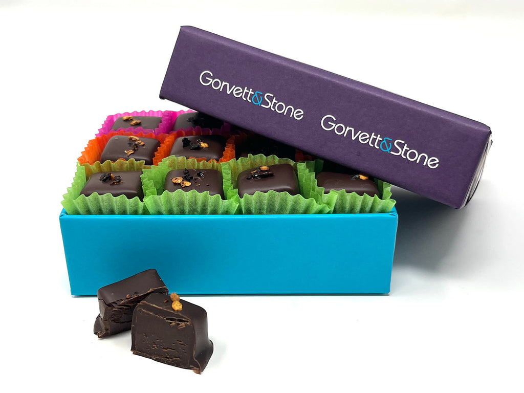 Partially open box of chocolates on a white background