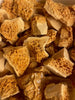 Large chunks of broken cinder toffee without chocolate.