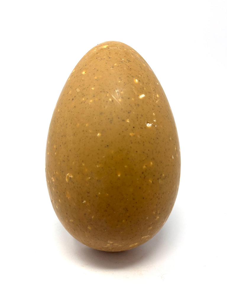 Blond chocolate Easter Egg speckled with coffee and popcorn. On a white background.