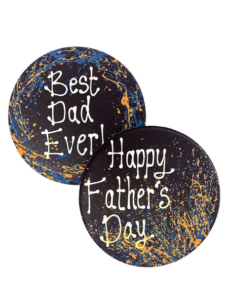 Two round dark chocolate father's day plaques. Decorated with blue and orange splashes and piped Best Dad Ever! and Happy Father's Day. On a white background.