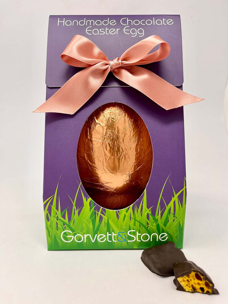 Handmade 70% dark chocolate Easter egg with honeycomb in a purple box with a pink ribbon, featuring the brand 'Gorvett & Stone.