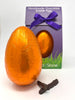 Handmade 70% dark chocolate orange Easter egg wrapped in orange foil with a purple ribbon and 'Gorvett & Stone' branding.