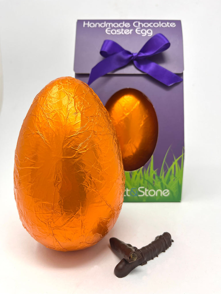 Handmade 70% dark chocolate orange Easter egg wrapped in orange foil with a purple ribbon and 'Gorvett & Stone' branding.