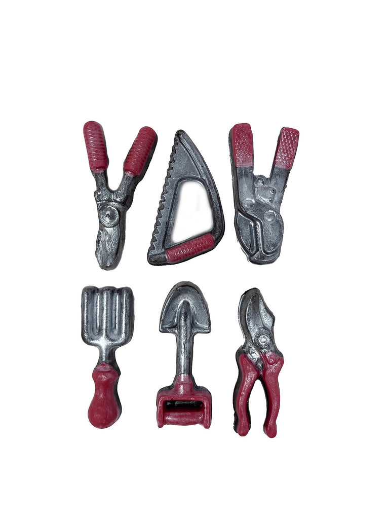 Set of miniature dark chocolate gardening tools with red handles on a white background.