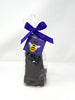 Dark chocolate honeycomb shards packaged in a clear bag tied with a ribbon and a bumble bee tag.  On a white background.