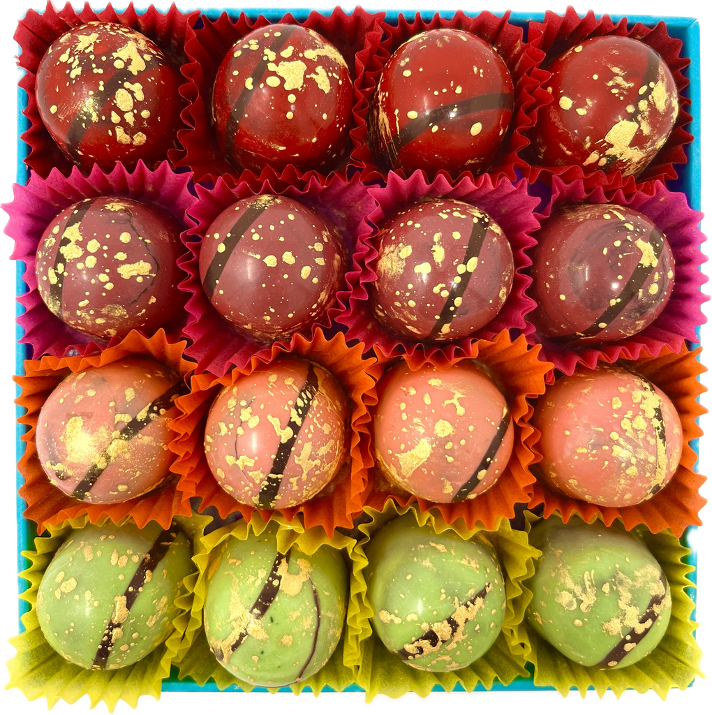 Box of 16 Fruity Fondants. Decorated with flecks of gold and shiny cocoa butter in red, purple, orange and green.