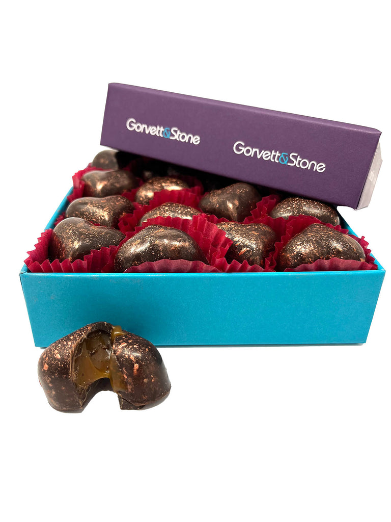 Open box of Gorvett & Stone chocolates with a purple lid and blue base.