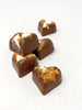 5 milk chocolate hearts with fragments on marshmallow and wafer arranged on a white background.