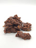 Chocolate-coated almond clusters on a white background