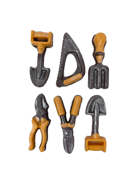 Set of miniature milk chocolate gardening tools with orange handles on a white background.