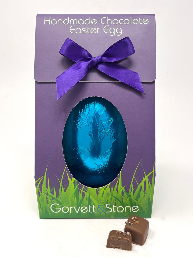 Handmade chocolate Easter egg in a purple box with a purple ribbon, featuring the brand 'Gorvett & Stone'.