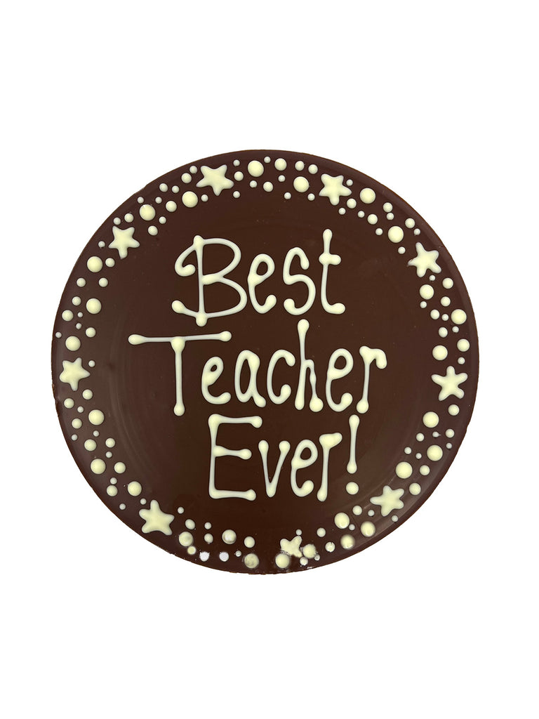 Chocolate  plaque with 'Best Teacher Ever!' text piped in white chocolate  and a border of stars and dots. On a white background.