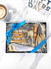Gift set of milk chocolate miniature garden  tools in a box on a marble surface with a coffee cup and 'Fathers Day' card.