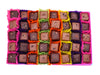 Open gift box of 40 dark and milk chocolates. Pictured in a chequerboard design and each chocolate sitting in a colourful petit four case. Pictured from above on a white background.